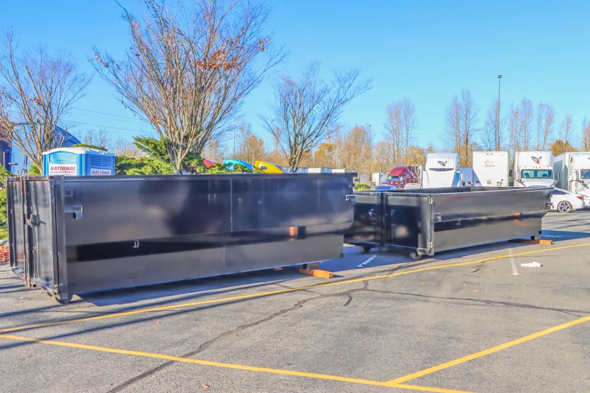 Professional dumpster rental service with roll-off container on residential driveway in Carencro